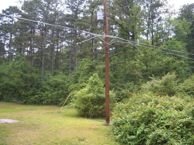 6462 Pisgah Road Southwest Austell, GA 30168 - Photo 1 of 1 a backyard of a building with lots of trees