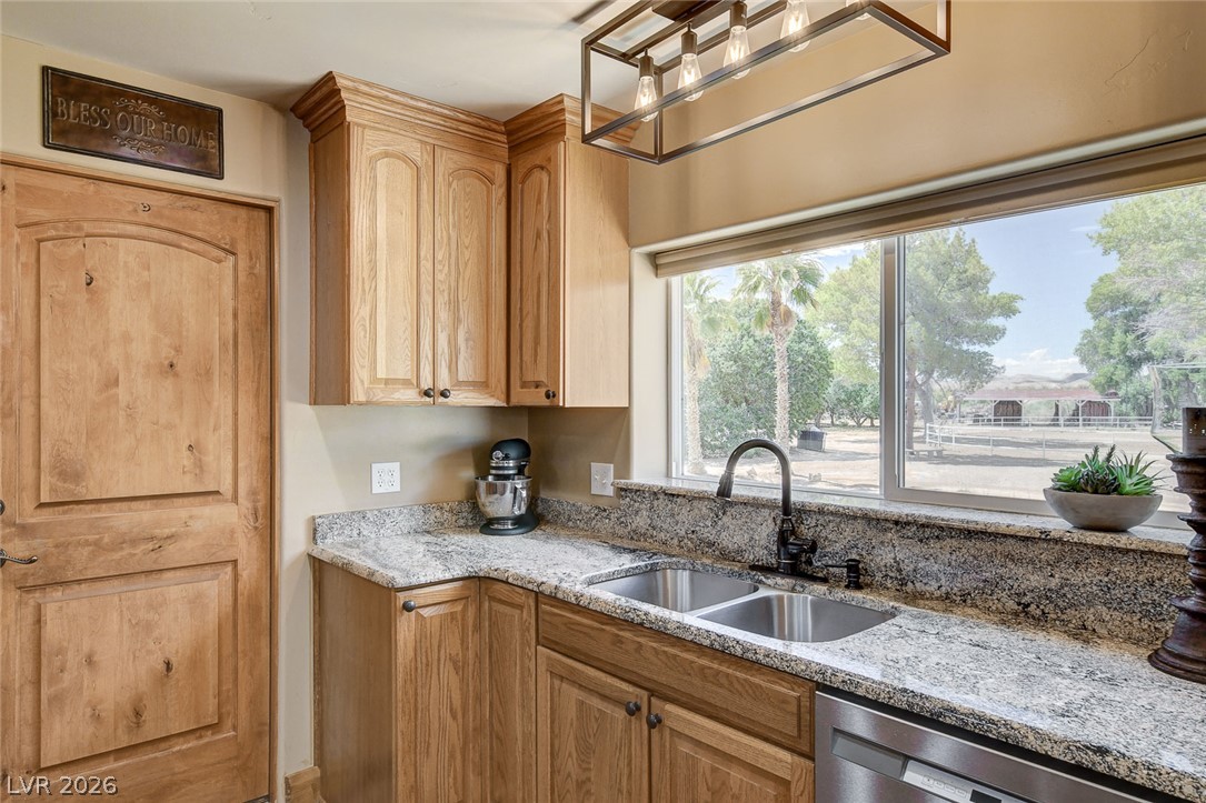1950 Bowman Road Logandale, NV 89021 - Photo 16 of 81 Granite counters and light wood oak cabinetry define this kitchen, offering a serene view of the expansive property.