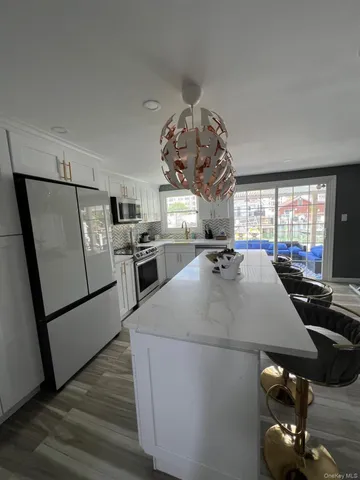 a kitchen with stainless steel appliances granite countertop a sink dishwasher stove and refrigerator
