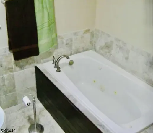 a bathroom with a bathtub and sink