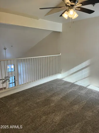a view of an empty room with a fan
