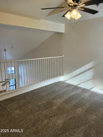a view of an empty room with a fan