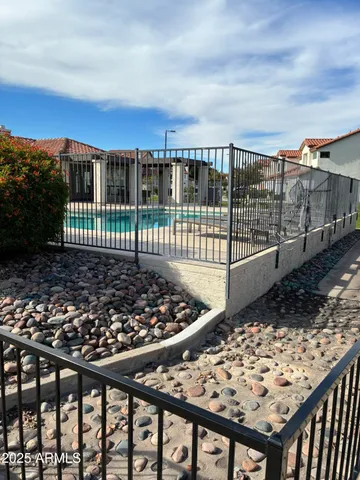 a view of a balcony with wooden fence