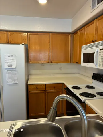 a kitchen with a sink and a microwave