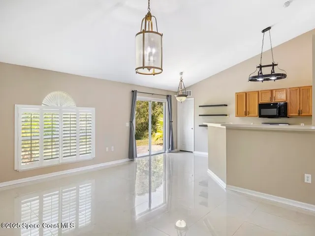 a view of a kitchen with an empty space and a window