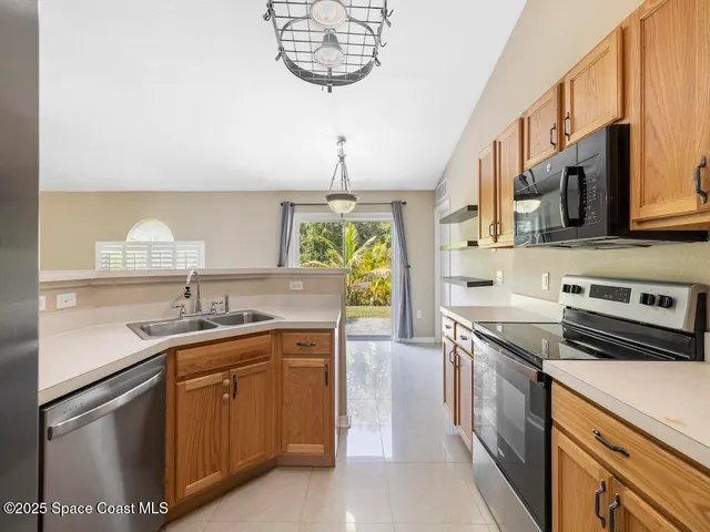 a kitchen with a sink cabinets and window