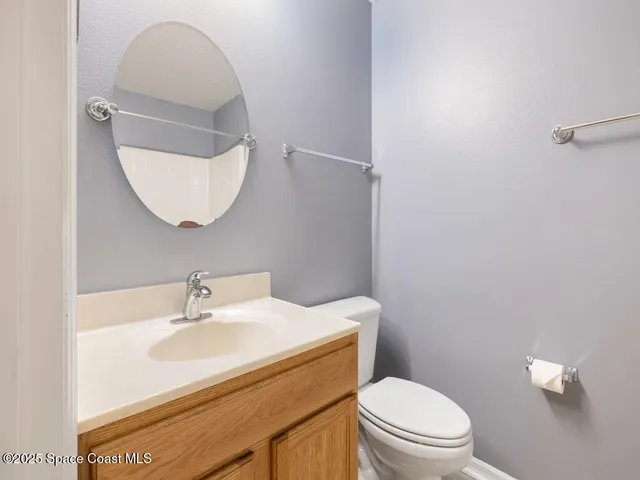 a bathroom with a sink a toilet and mirror