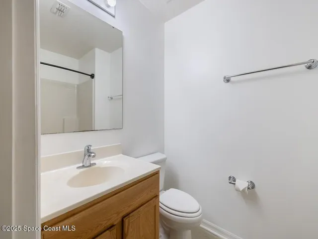 a bathroom with a sink toilet and a mirror