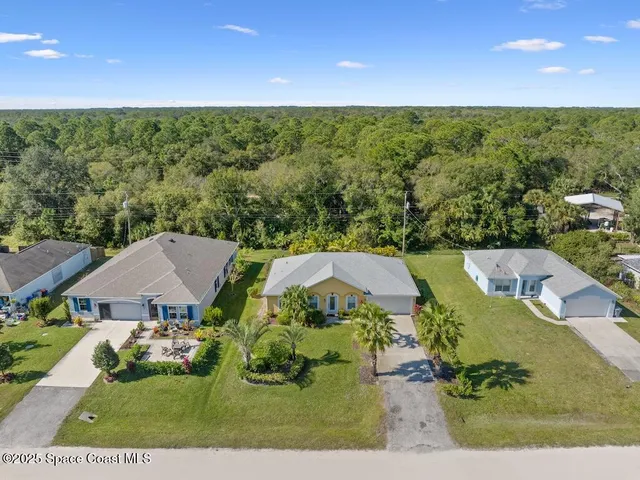 an aerial view of a house with a garden