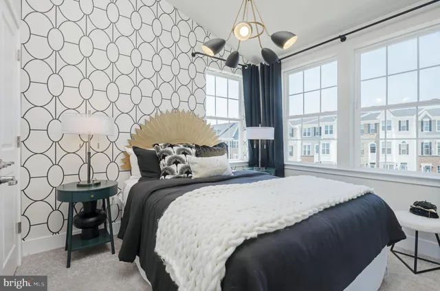 a bedroom with a bed and a large window