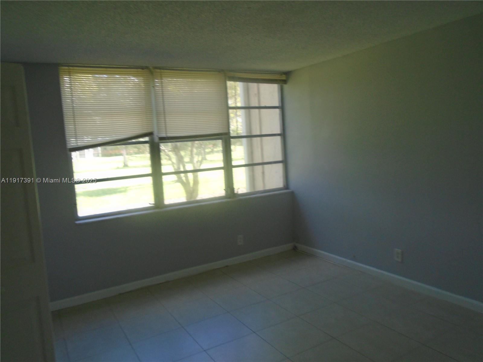 7051 Environ Boulevard, Unit 136 Lauderhill, FL 33319 - Photo 13 of 23 an empty room with a window