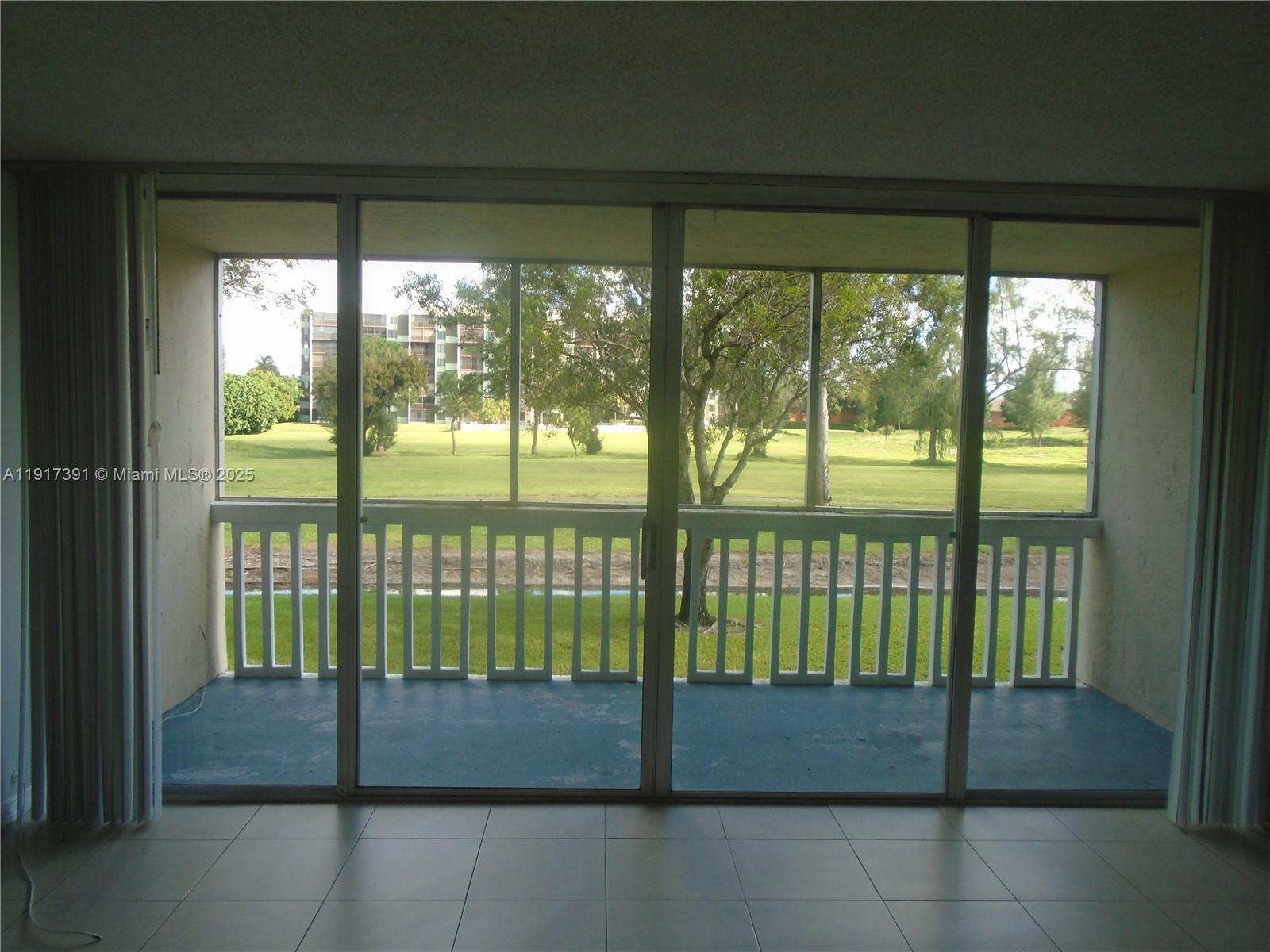 7051 Environ Boulevard, Unit 136 Lauderhill, FL 33319 - Photo 19 of 23 a view of porch with a floor to ceiling window and outside view