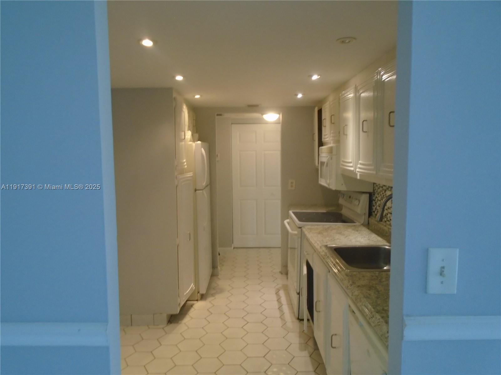 7051 Environ Boulevard, Unit 136 Lauderhill, FL 33319 - Photo 21 of 23 a bathroom with a sink a toilet and shower