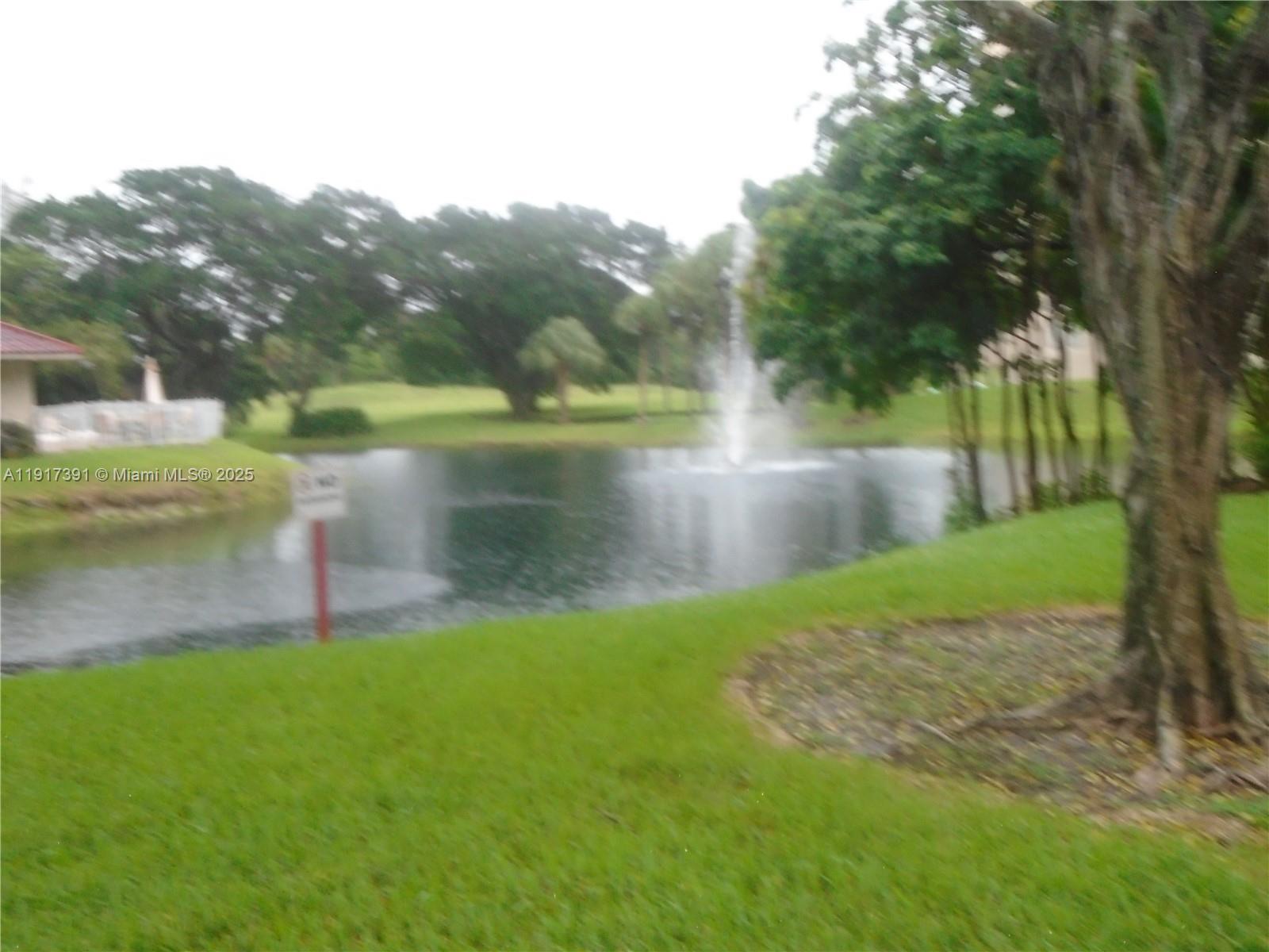 7051 Environ Boulevard, Unit 136 Lauderhill, FL 33319 - Photo 3 of 23 a view of a lake with a large trees
