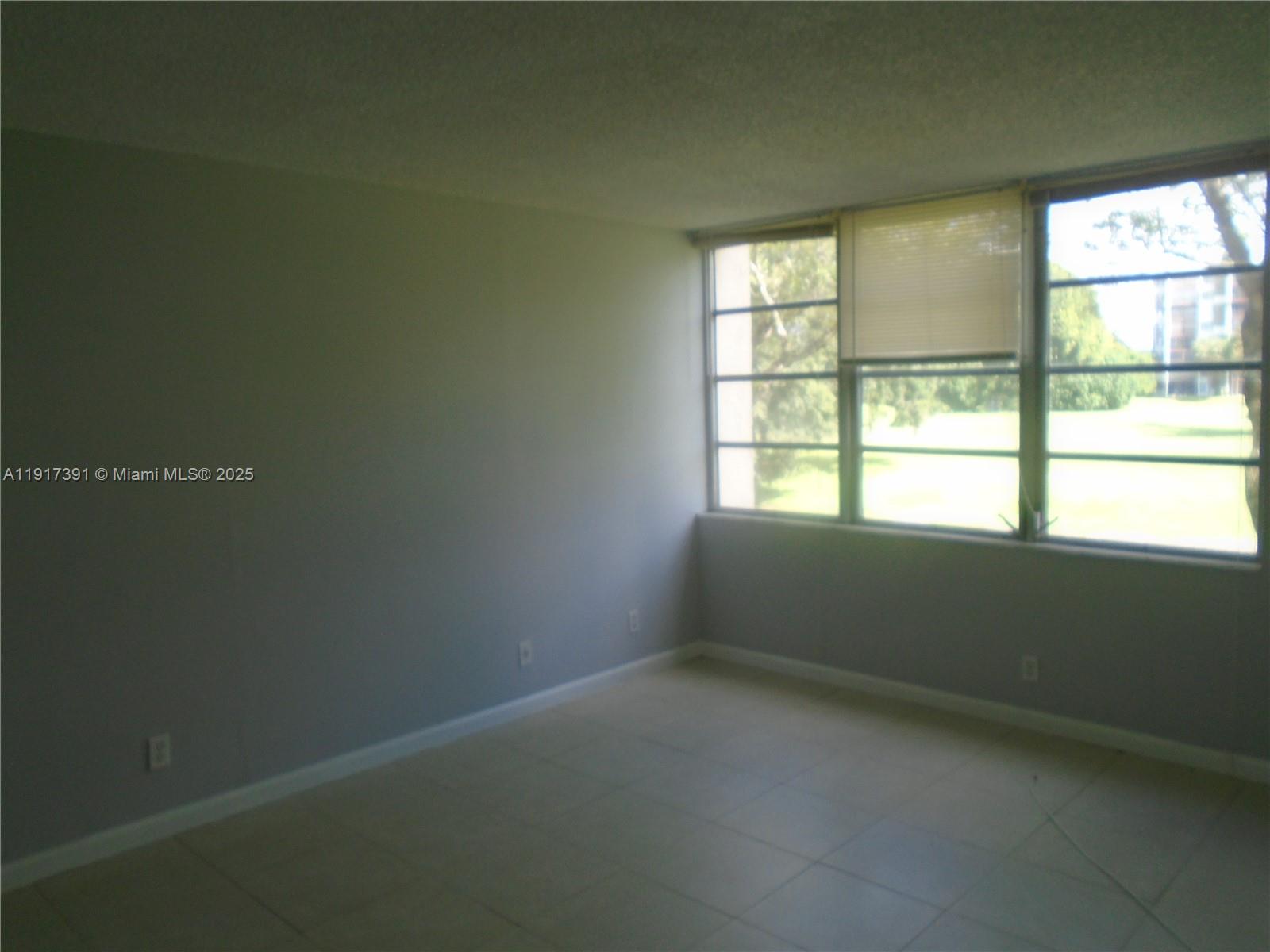 7051 Environ Boulevard, Unit 136 Lauderhill, FL 33319 - Photo 8 of 23 an empty room with a window