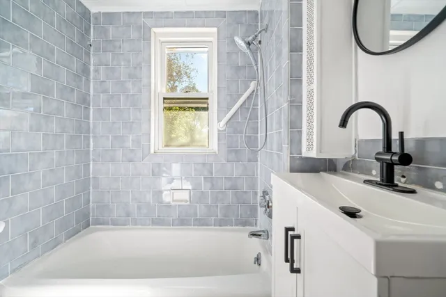 a bathroom with a sink a bathtub and a shower