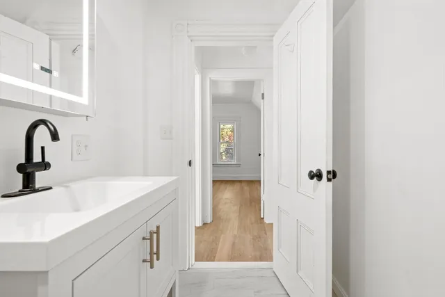 a bathroom with a sink and mirror