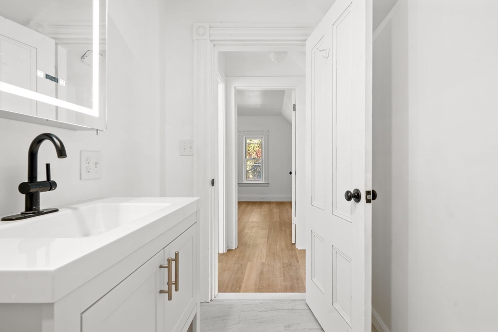 166 Elliot Street, Unit 2 Newton, MA 02464 - Photo 13 of 20 a bathroom with a sink and mirror