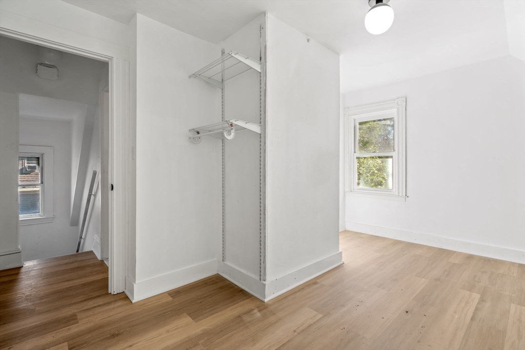 166 Elliot Street, Unit 2 Newton, MA 02464 - Photo 16 of 20 a view of a hallway with wooden floor and closet