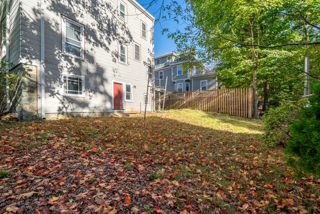 a view of the house with a yard