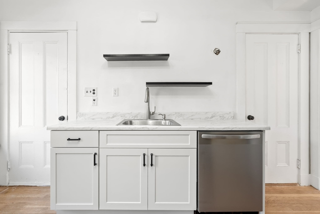 166 Elliot Street, Unit 2 Newton, MA 02464 - Photo 2 of 20 a sink with white cabinets