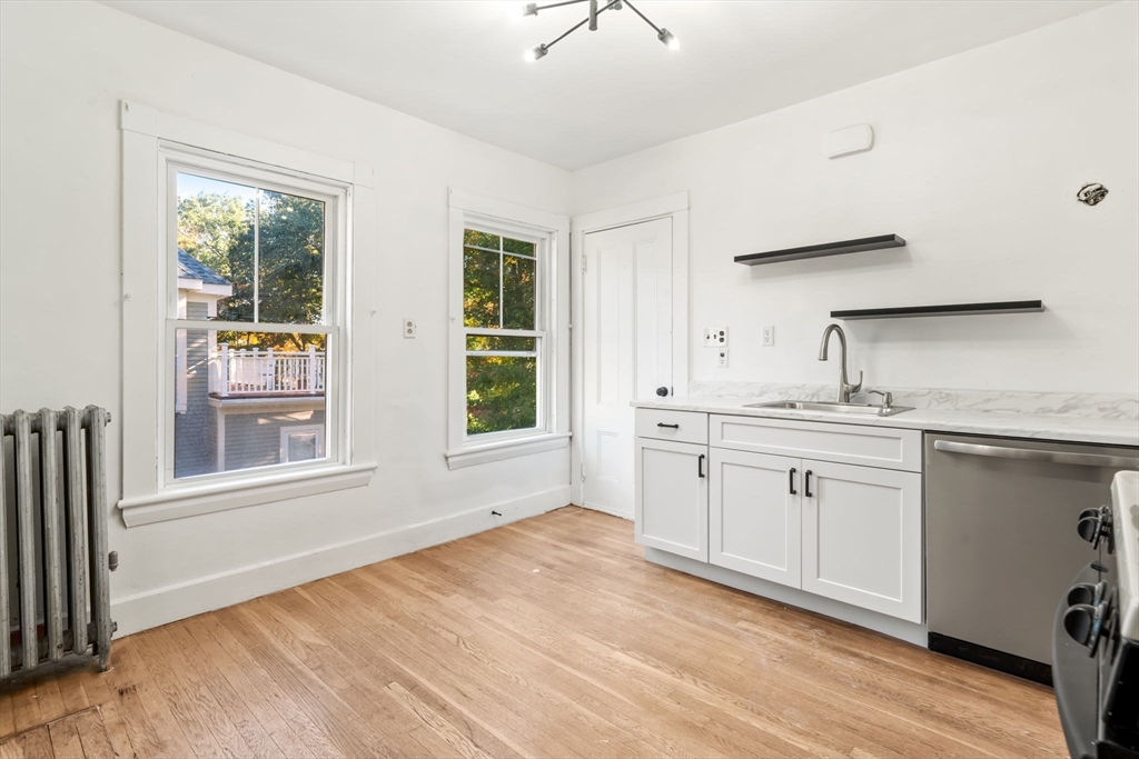 166 Elliot Street, Unit 2 Newton, MA 02464 - Photo 3 of 20 a spacious bathroom with a granite countertop sink and a window
