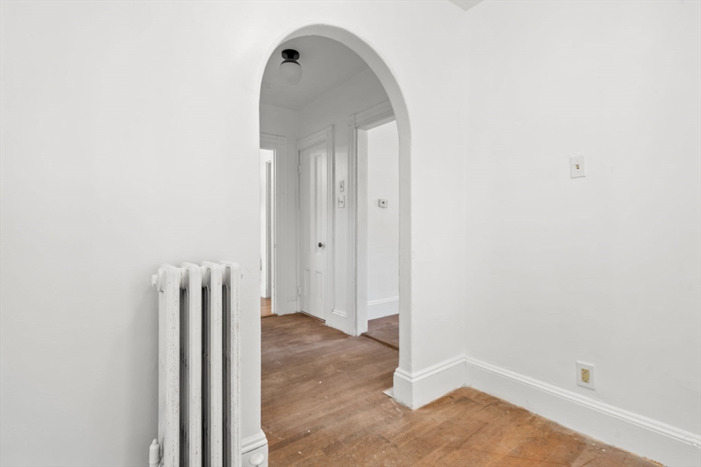 166 Elliot Street, Unit 2 Newton, MA 02464 - Photo 10 of 20 an empty room with wooden floor and a window