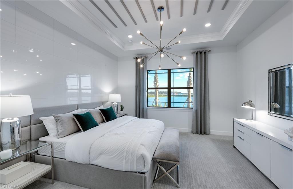 20155 Napa Loop Estero, FL 33928 - Photo 14 of 35 a spacious bedroom with a bed and a large window