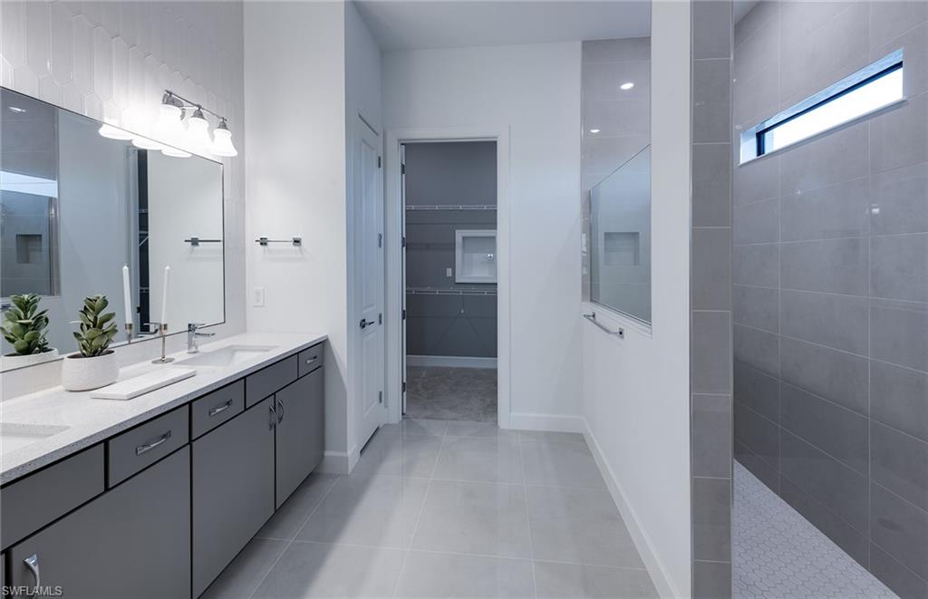 20155 Napa Loop Estero, FL 33928 - Photo 15 of 35 a bathroom with a double vanity sink mirror and shower
