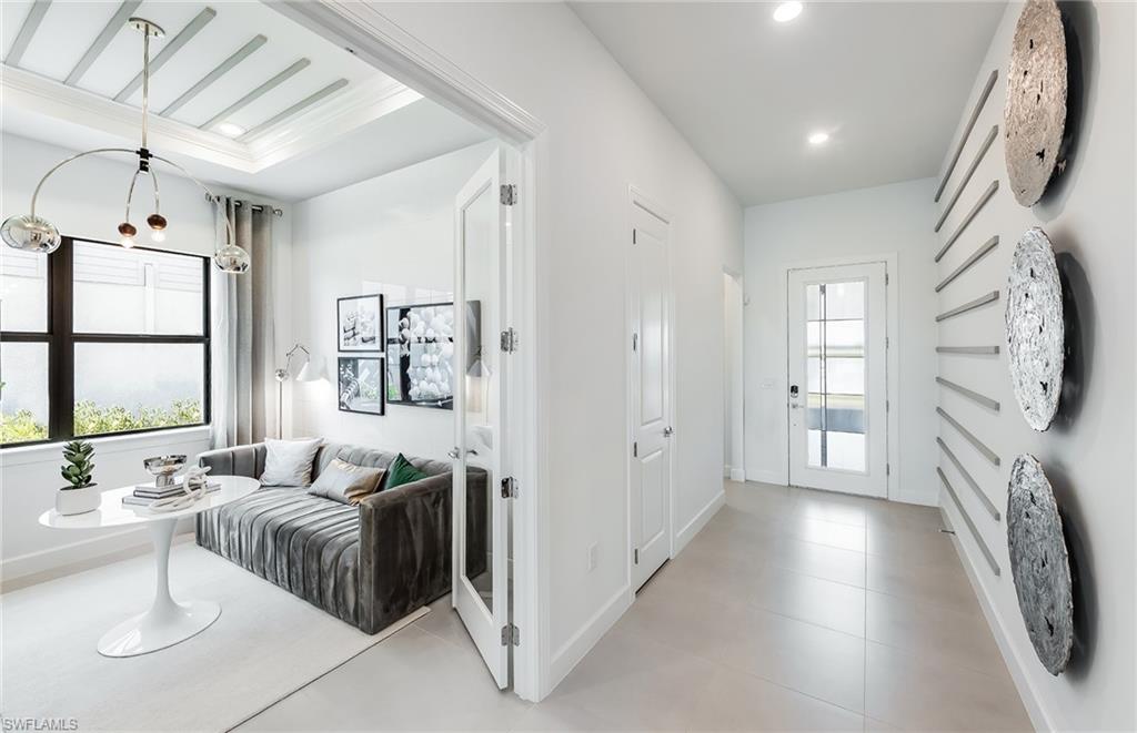 20155 Napa Loop Estero, FL 33928 - Photo 19 of 35 a spacious bedroom with a bed couch and a window