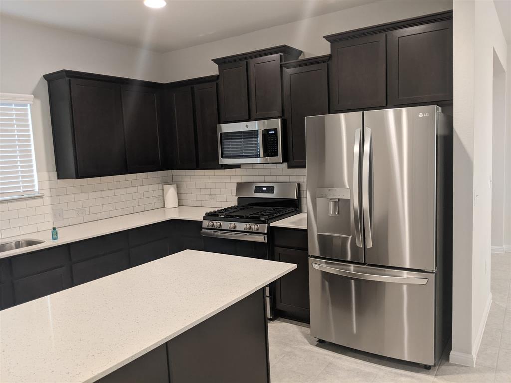 6404 Gunflint Drive Austin, TX 78747 - Photo 5 of 21 Culinary delights await in this sleek kitchen featuring premium appliances and ample counter space.
