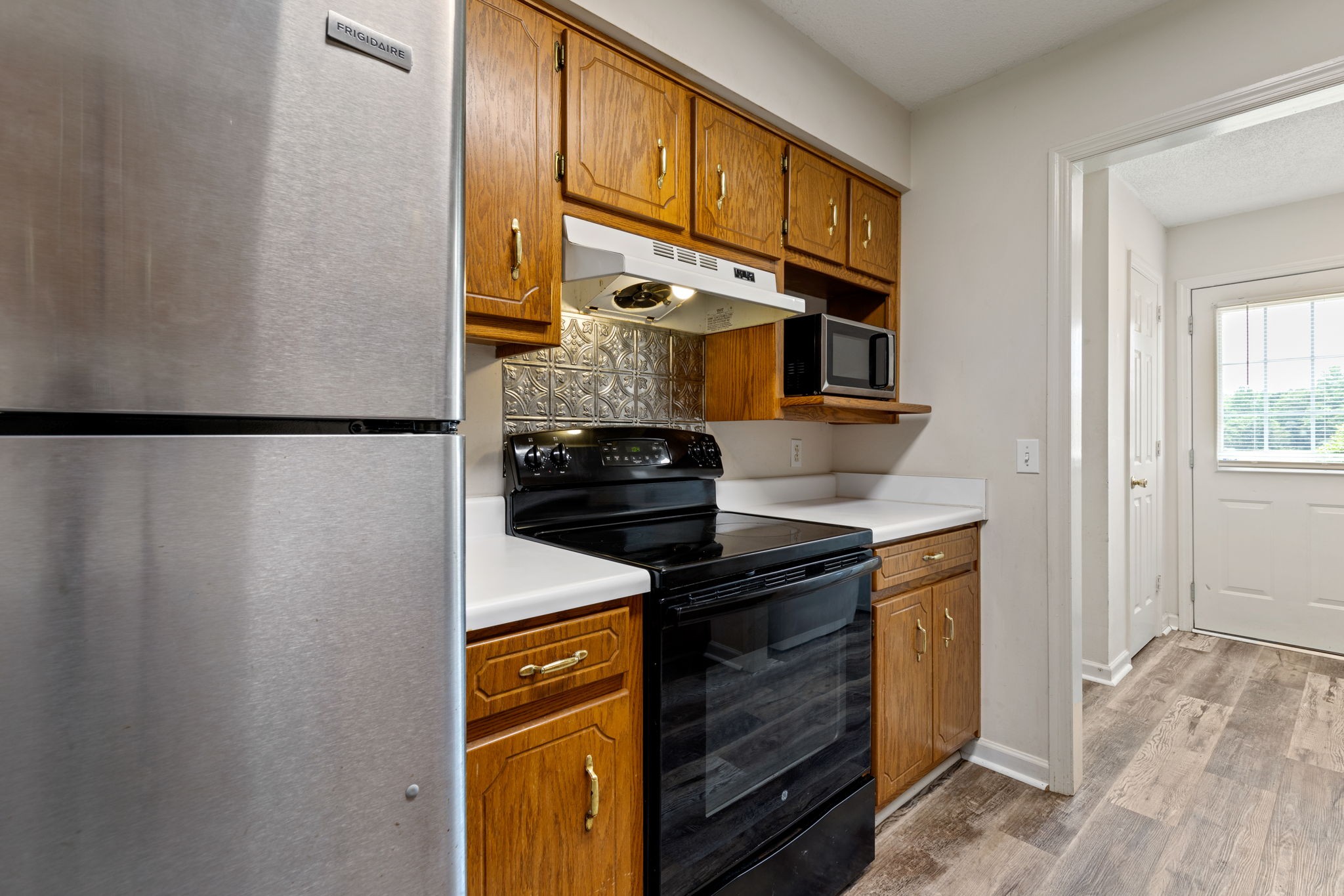 889 6 Mile Board Road Belvidere, TN 37306 - Photo 11 of 27 a kitchen with stainless steel appliances granite countertop a stove and a refrigerator