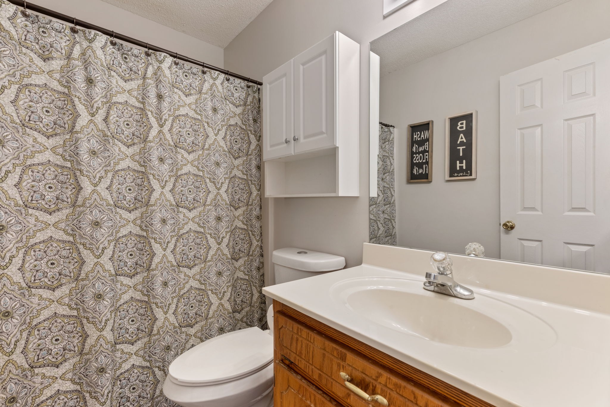 889 6 Mile Board Road Belvidere, TN 37306 - Photo 25 of 27 a bathroom with a sink a toilet and shower curtain