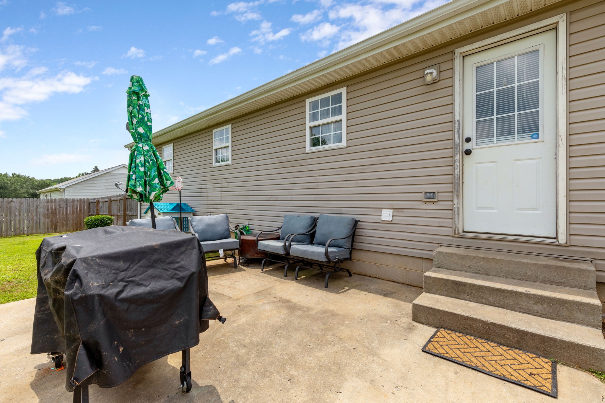 889 6 Mile Board Road Belvidere, TN 37306 - Photo 26 of 27 a view of a patio with table and chairs with wooden floor and fence
