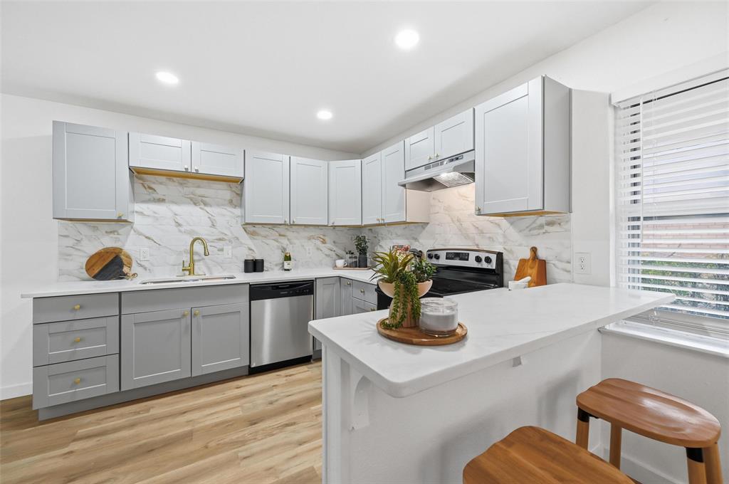 816 Green Cove Lane Dallas, TX 75232 - Photo 11 of 24 a kitchen with a sink cabinets and wooden floor