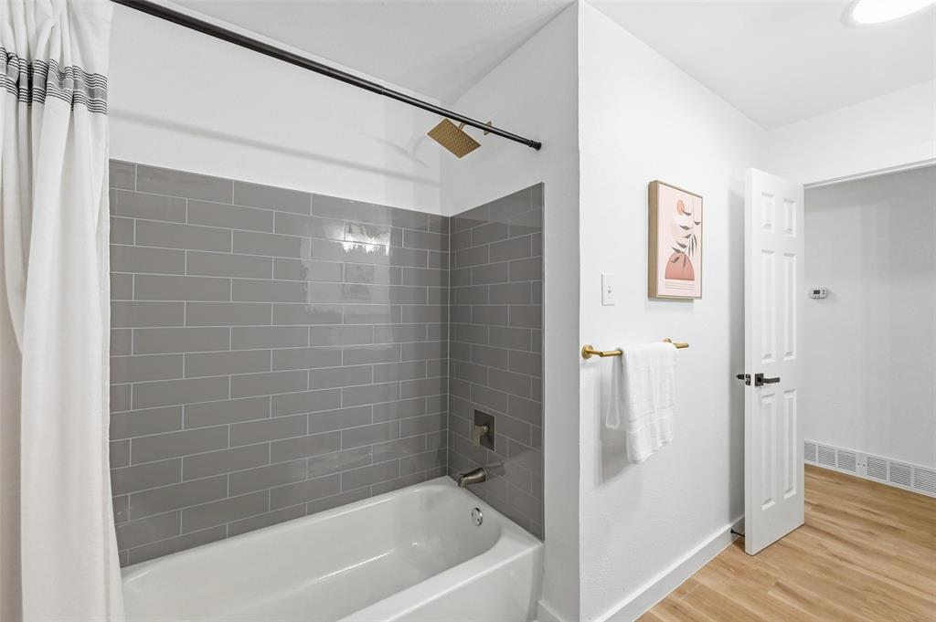 816 Green Cove Lane Dallas, TX 75232 - Photo 16 of 24 a bathroom with a bathtub and shower