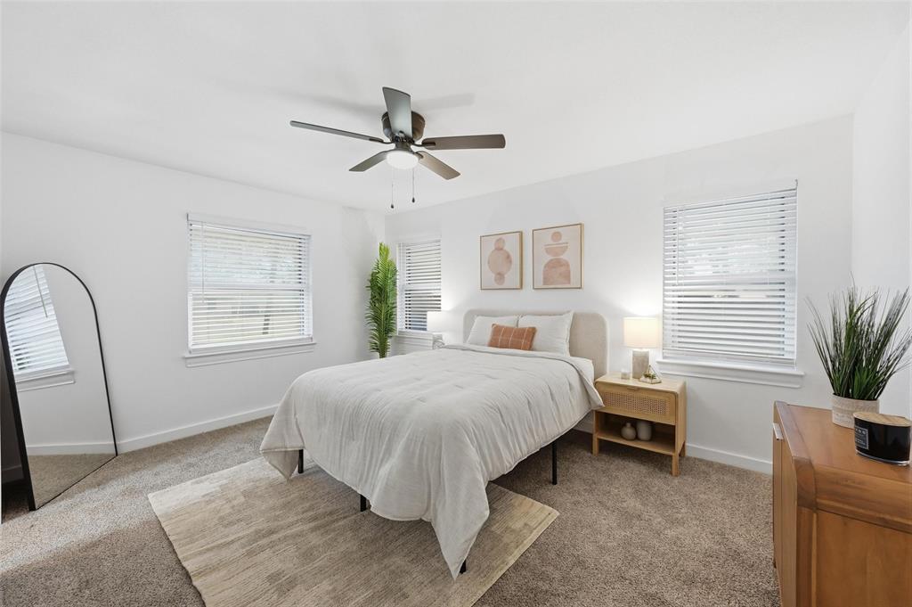 816 Green Cove Lane Dallas, TX 75232 - Photo 17 of 24 a bedroom with a large bed and a window