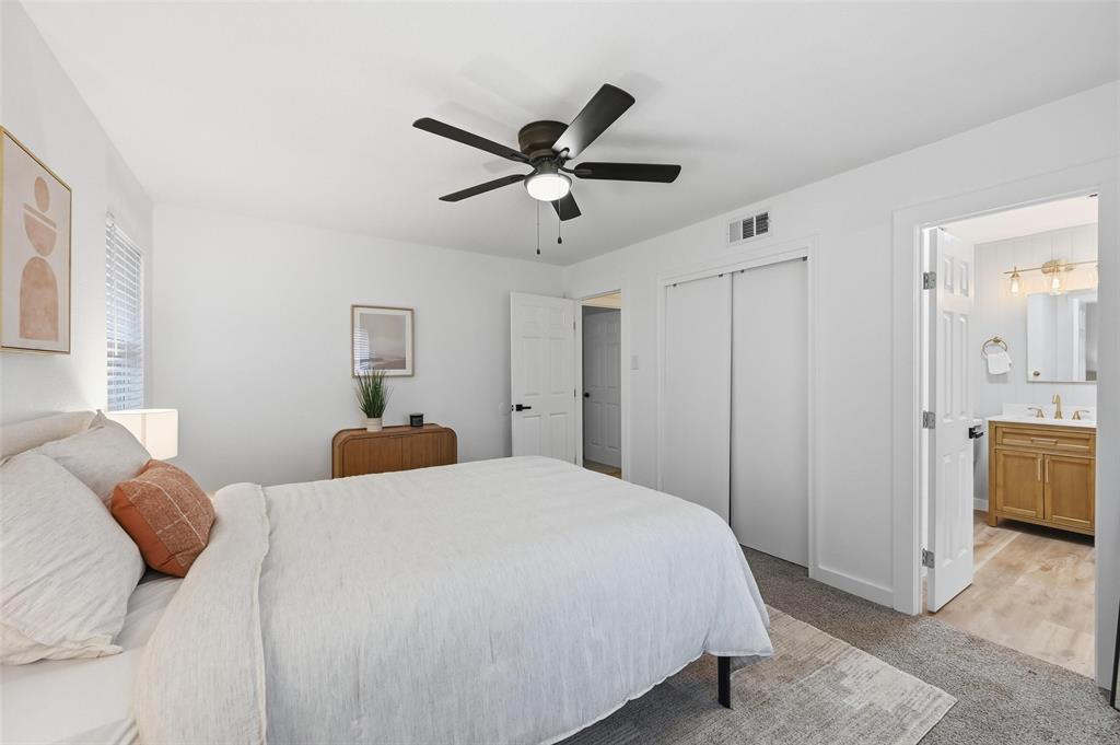 816 Green Cove Lane Dallas, TX 75232 - Photo 18 of 24 a bedroom with a large bed and a chandelier