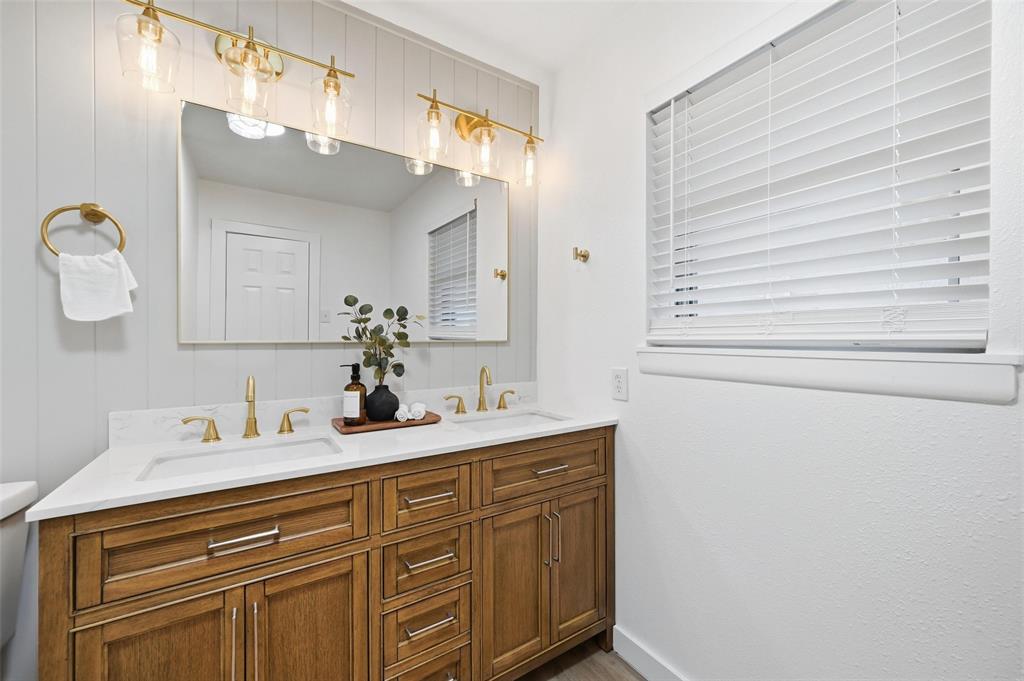 816 Green Cove Lane Dallas, TX 75232 - Photo 19 of 24 a bathroom with a sink and a mirror