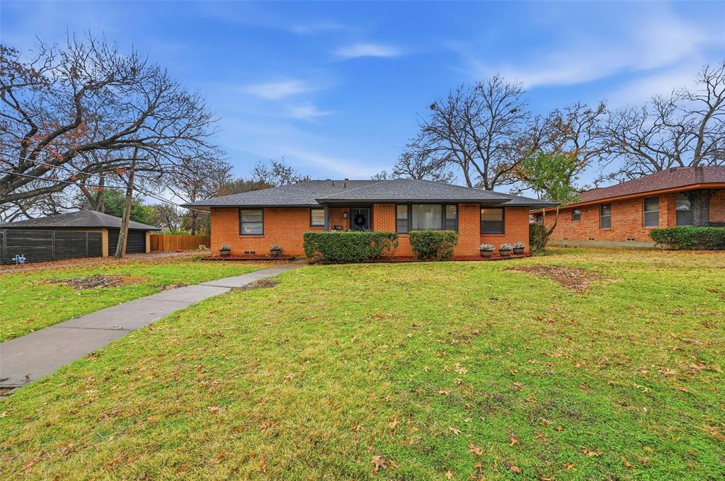 816 Green Cove Lane Dallas, TX 75232 - Photo 7 of 24 a front view of a house with a yard