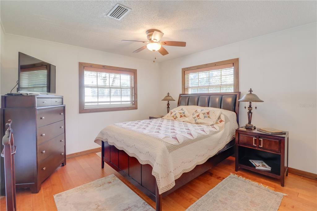 1480 Northeast 97th St Road Anthony, FL 32617 - Photo 16 of 35 a bed sitting in a bedroom next to a window