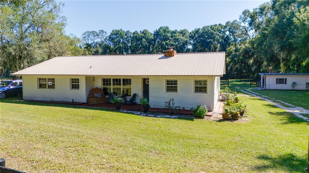 1480 Northeast 97th St Road Anthony, FL 32617 - Photo 31 of 35 a view of a house with swimming pool and sitting area