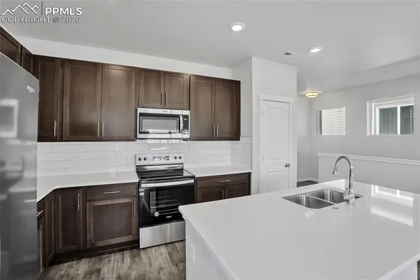 a kitchen with a stove and a microwave