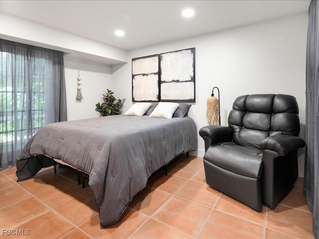 1046 Sperling Avenue Naples, FL 34103 - Photo 12 of 18 a bedroom with a bed couch and window