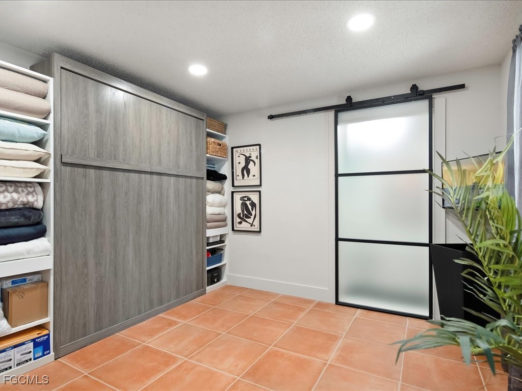 1046 Sperling Avenue Naples, FL 34103 - Photo 15 of 18 a view of a refrigerator in kitchen and an empty room