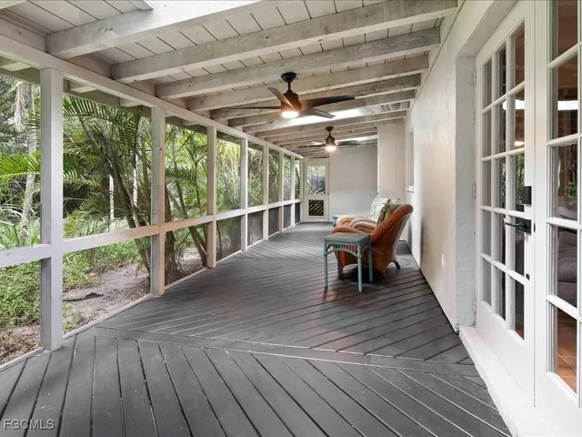 a view of a porch with wooden floor and outdoor seating