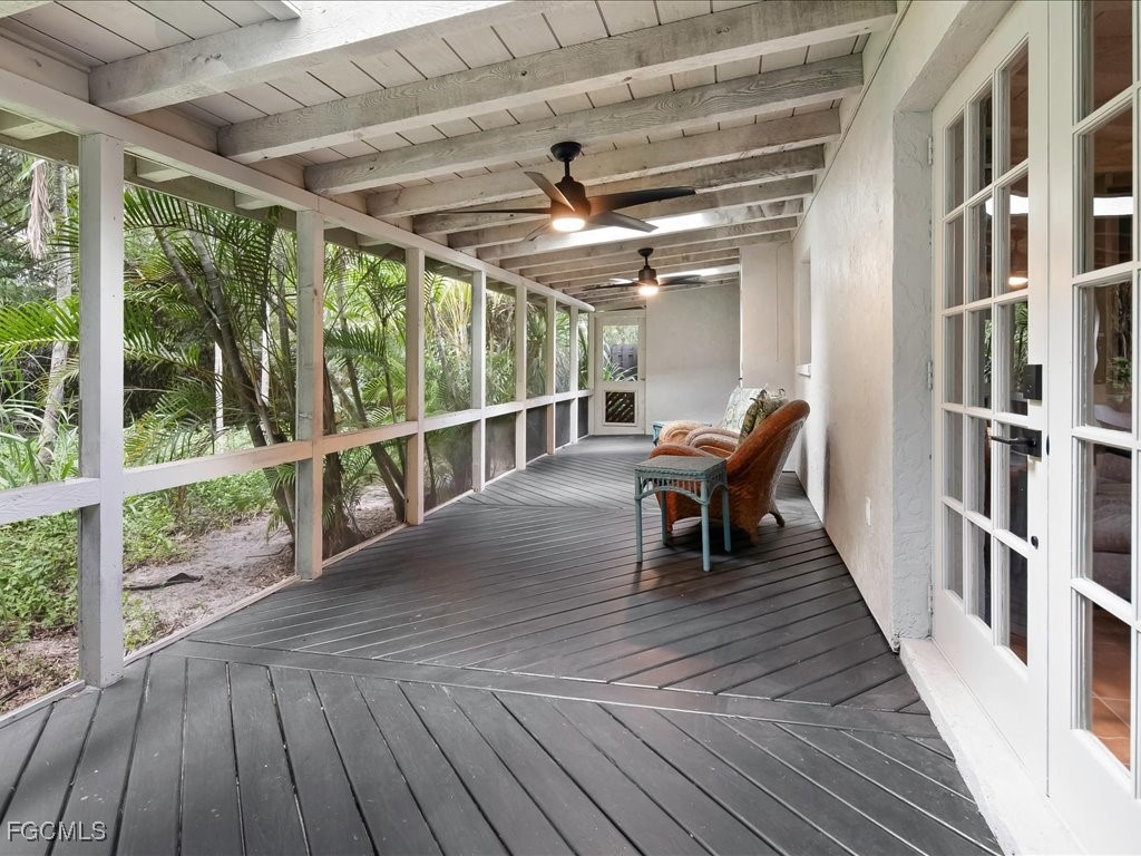 1046 Sperling Avenue Naples, FL 34103 - Photo 17 of 18 a view of a porch with wooden floor and outdoor seating