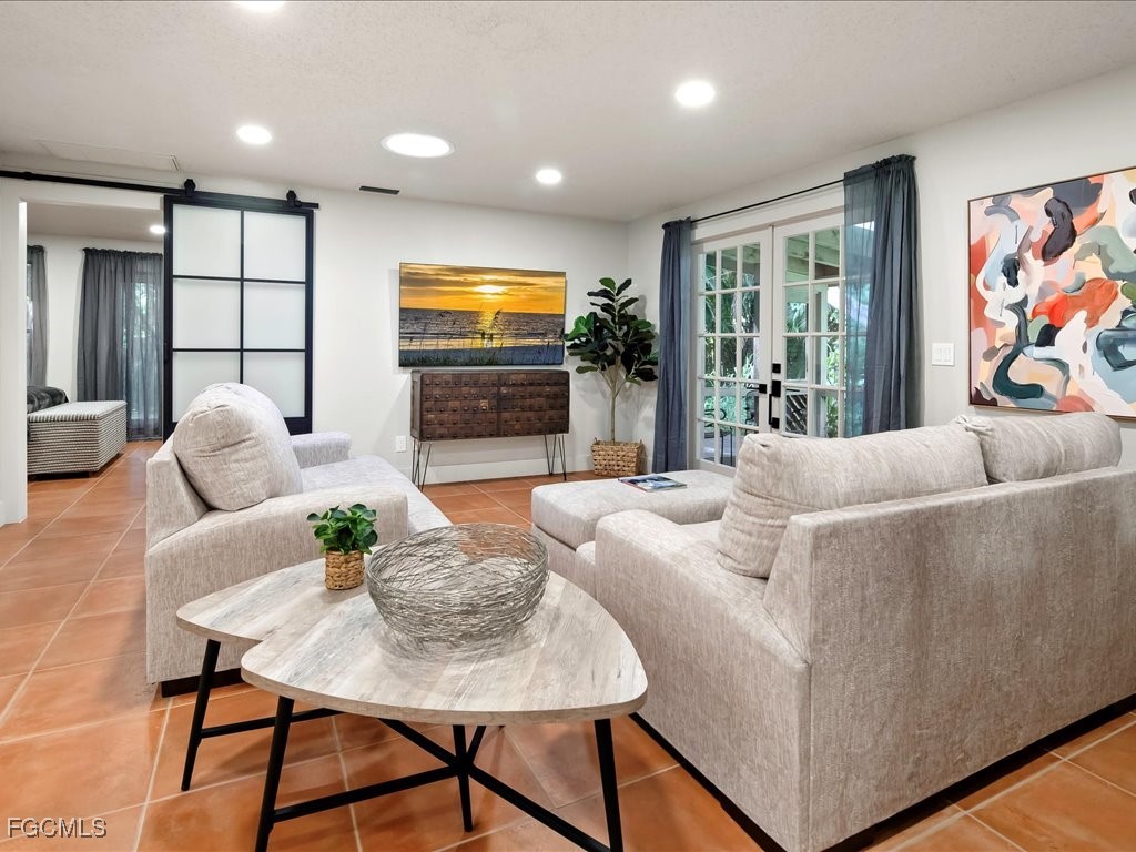 1046 Sperling Avenue Naples, FL 34103 - Photo 5 of 18 a living room with furniture and a flat screen tv