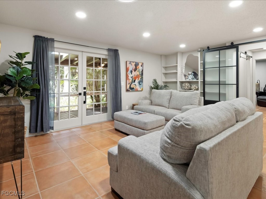 1046 Sperling Avenue Naples, FL 34103 - Photo 6 of 18 a living room with furniture and a large window