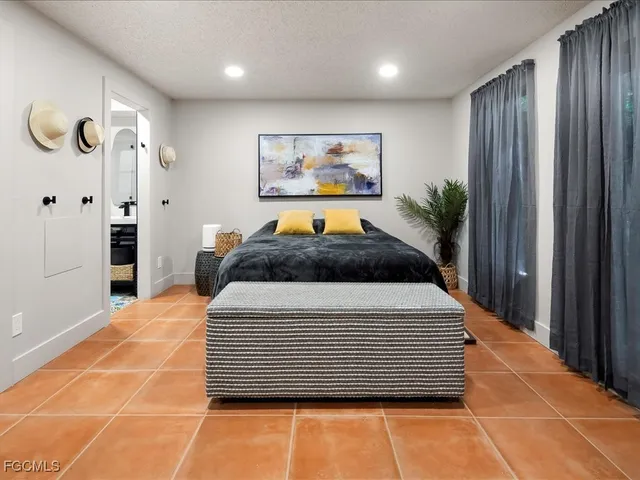 a bedroom with a large bed and a chandelier